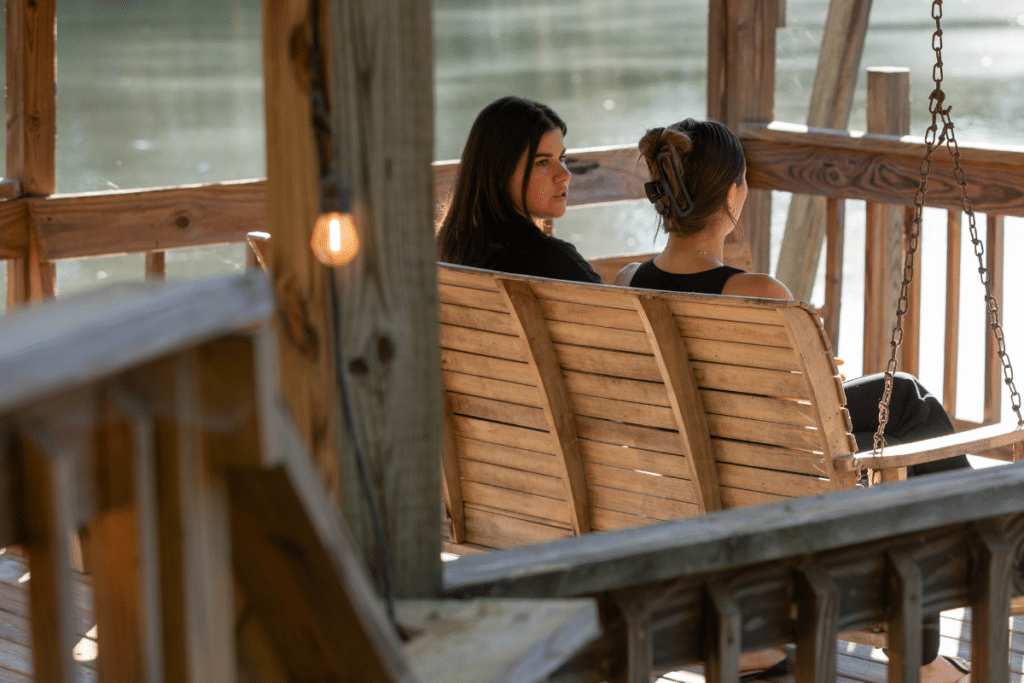 Magnolia Creek Grounds - clients on switch looking over lake