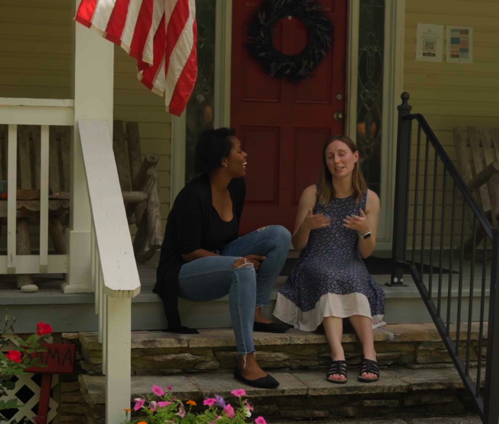 Clients sitting on steps of main house